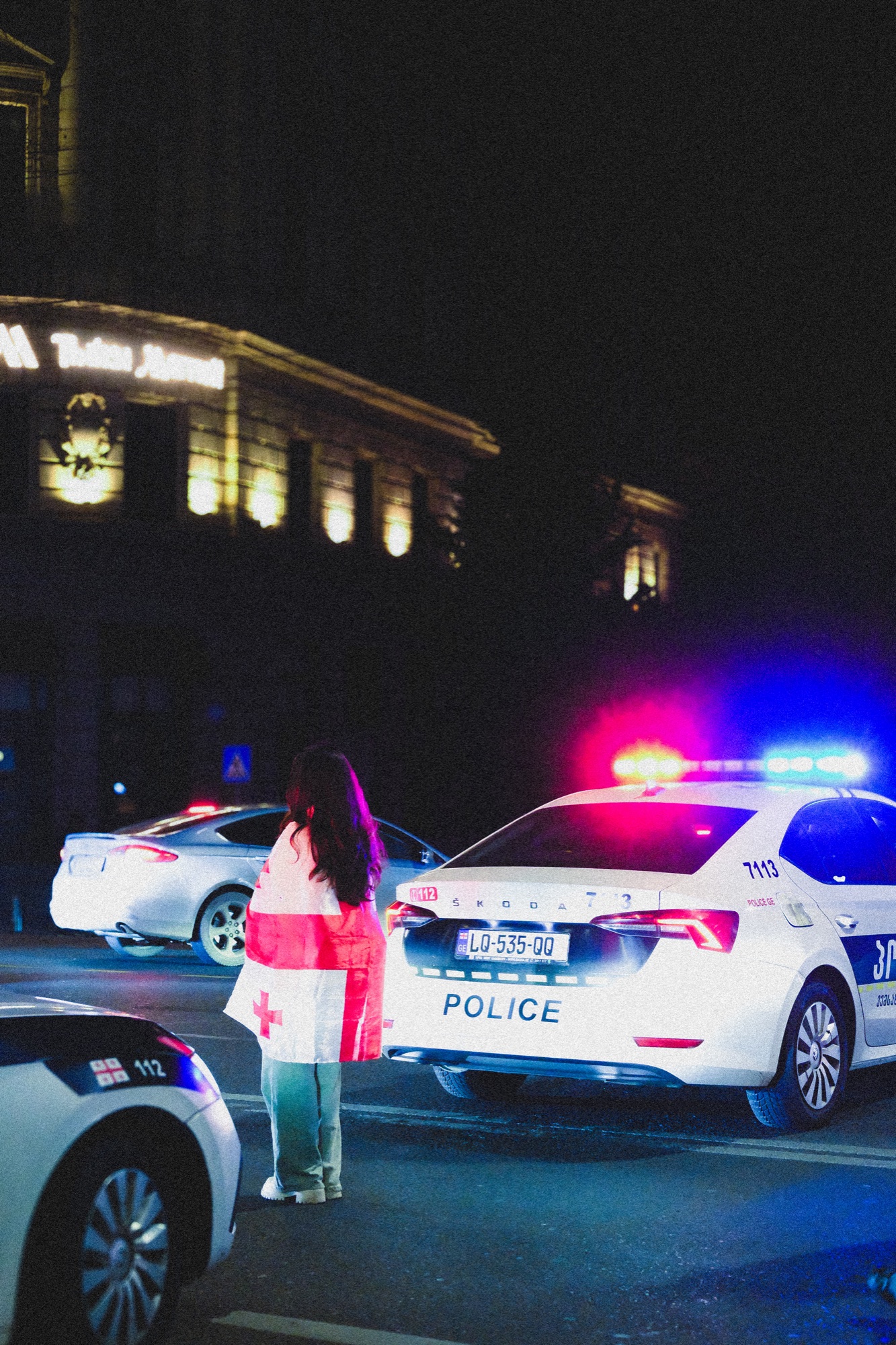 Night street scene with police lights, Tbilisi