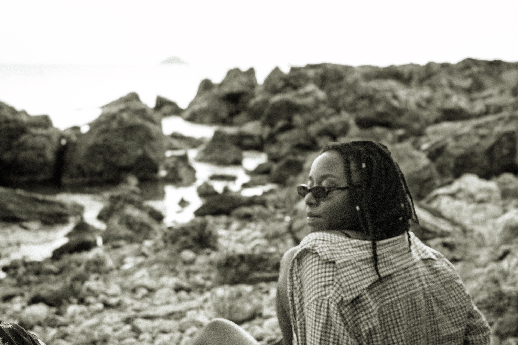 Portrait at rocky coastline, black and white