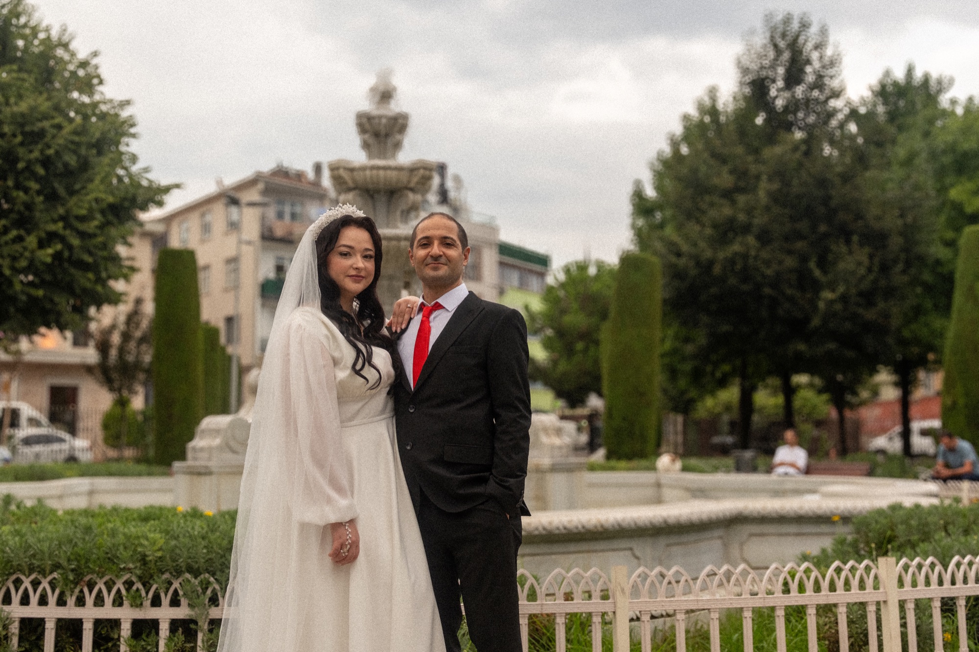 Wedding couple at fountain in park