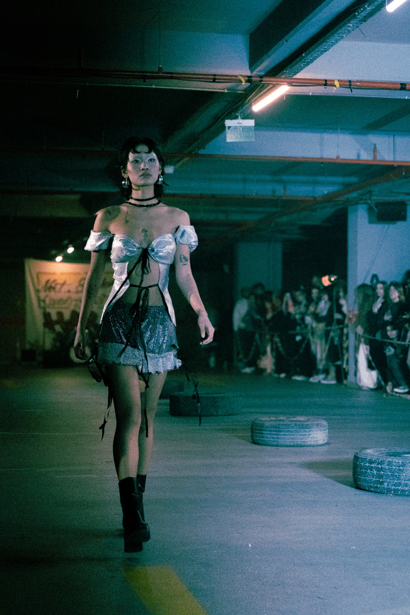 Model walking underground parking garage runway