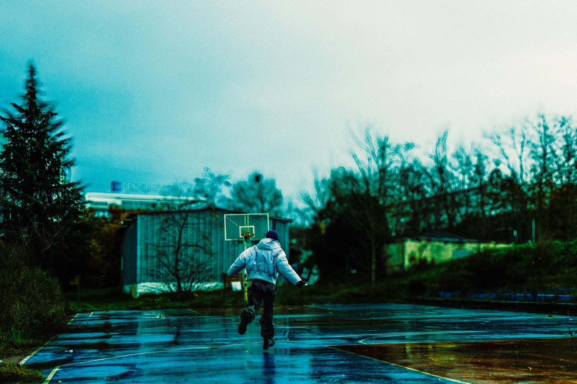 Person running on wet basketball court